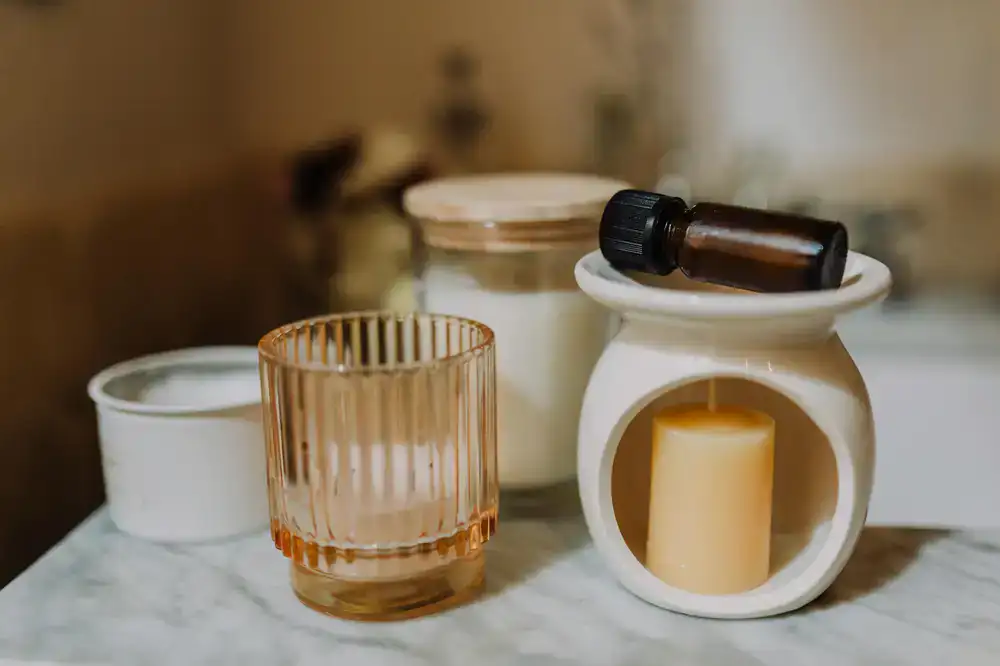 A collection of fragrance oil bottles and raw wax