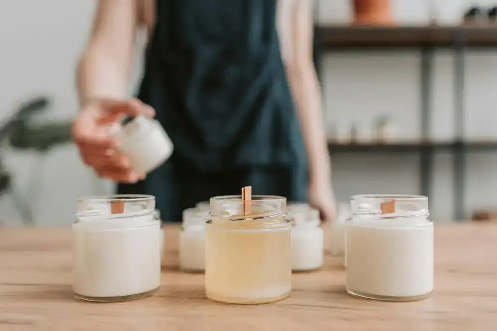 A tidy workshop table with arranged wicks and empty jars