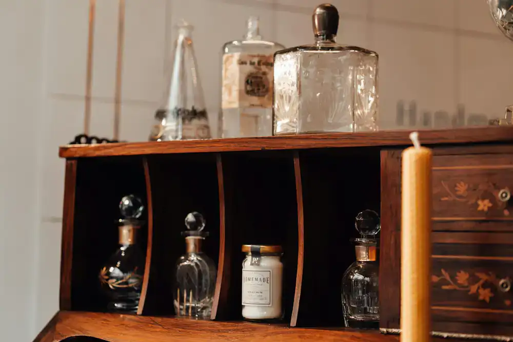 A beautiful display of handmade candles on a wooden boutique shelf